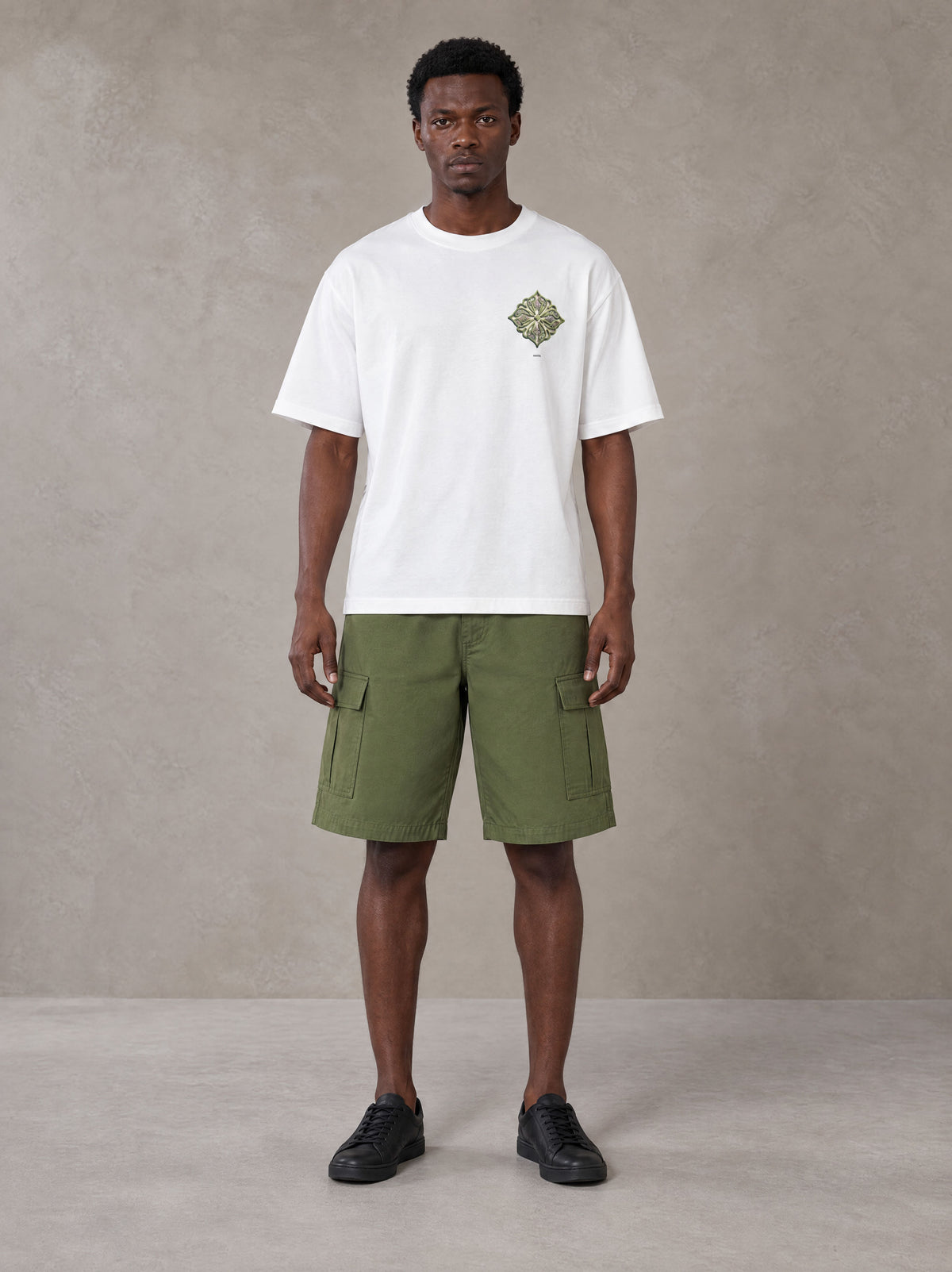 Model wearing SM Verdant Fleur T-shirt in Lucent White, front view.