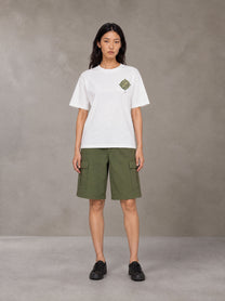 Model wearing SM Verdant Fleur T-shirt in Lucent White, front view.