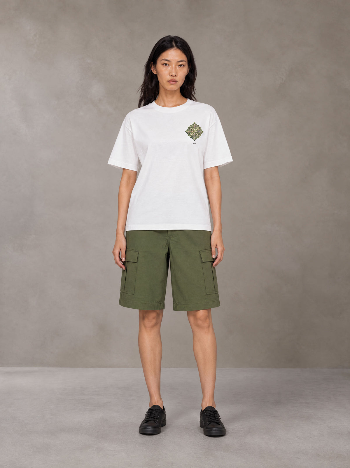 Model wearing SM Verdant Fleur T-shirt in Lucent White, front view.