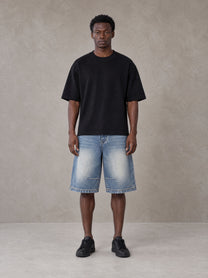 Model wearing SM Heritage Vintage Wash Denim Shorts in Cadet Grey, front view.