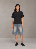 Model wearing SM Heritage Vintage Wash Denim Shorts in Cadet Grey, front view.
