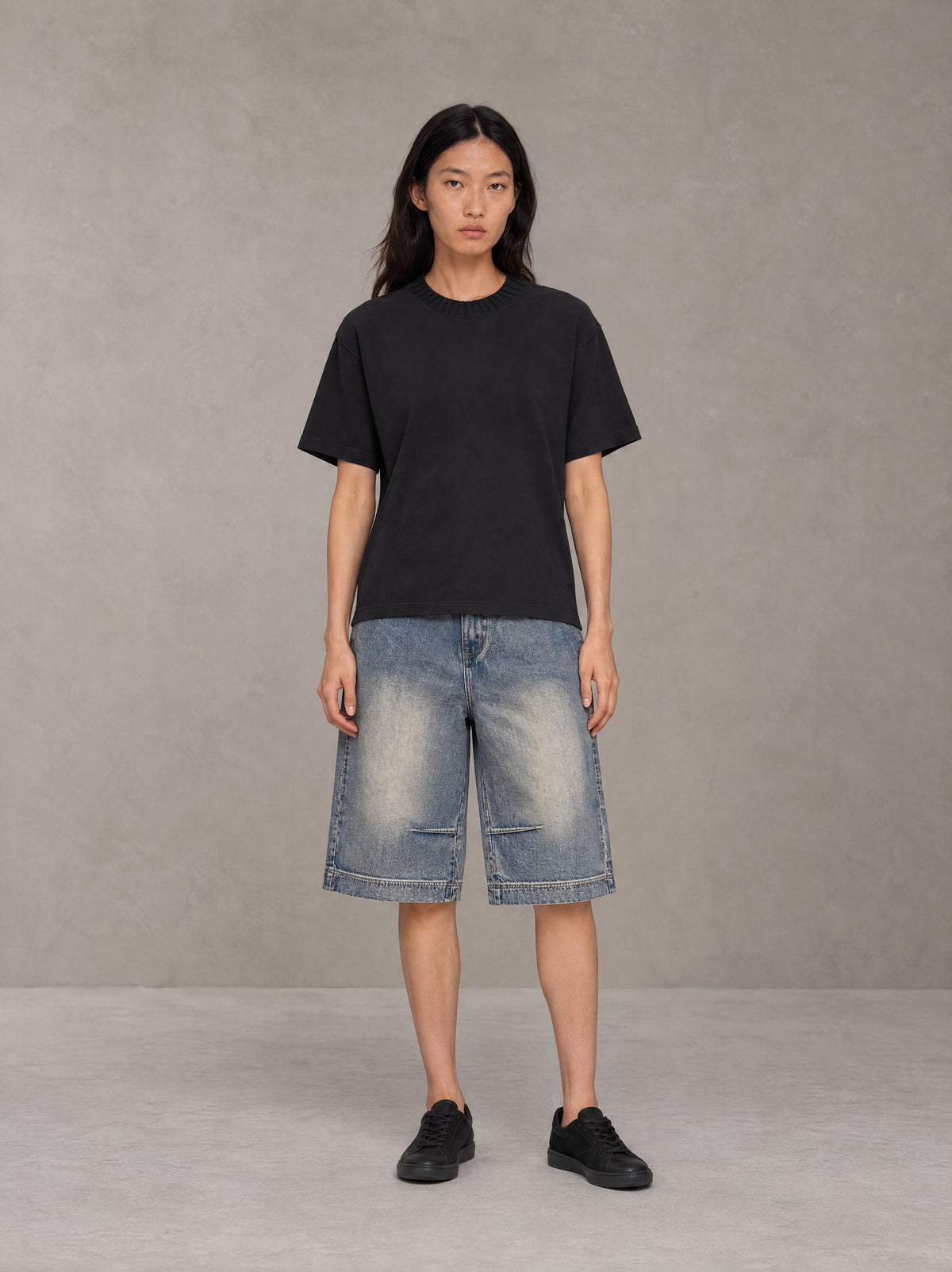 Model wearing SM Heritage Vintage Wash Denim Shorts in Cadet Grey, front view.