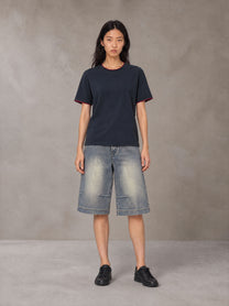 Model wearing SM Sunwash T-shirt in Oxford Navy, front view.