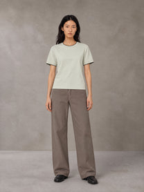 Model wearing SM Sunwash T-shirt in Moon Mist, front view.