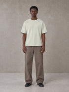 Model wearing SM Sunwash T-shirt in Moon Mist, front view.