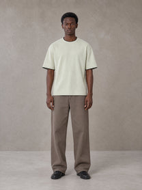 Model wearing SM Sunwash T-shirt in Moon Mist, front view.