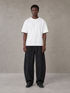 Model wearing SM Sunwash T-shirt in Lucent White, front view.