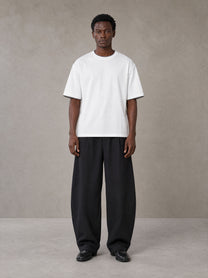 Model wearing SM Sunwash T-shirt in Lucent White, front view.