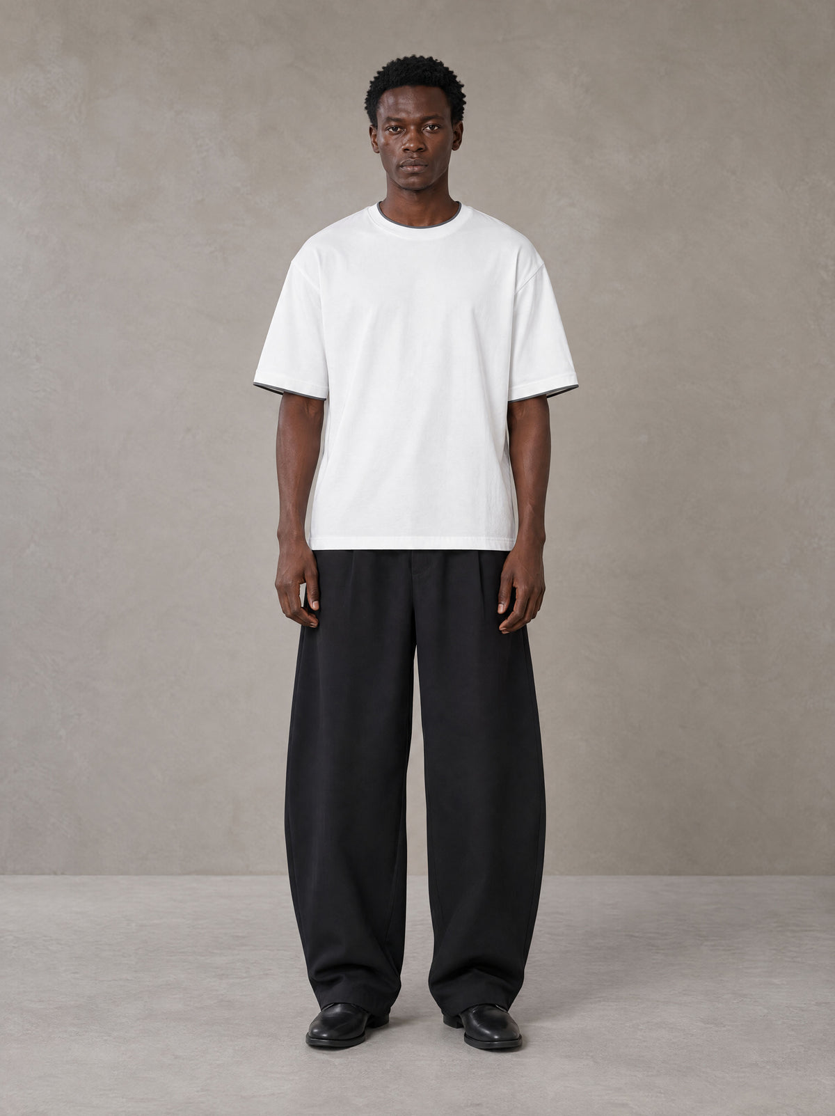 Model wearing SM Sunwash T-shirt in Lucent White, front view.