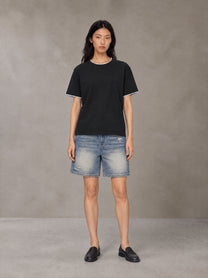 Model wearing SM Sunwash T-shirt in Midnight Black, front view.