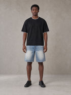 Model wearing SM Sunwash T-shirt in Midnight Black, front view.