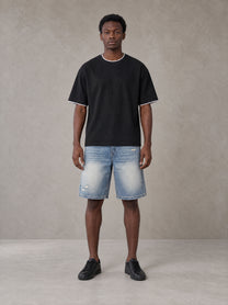 Model wearing SM Sunwash T-shirt in Midnight Black, front view.