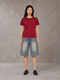 Model wearing SM Sunwash T-shirt in Deep Carmine, front view.