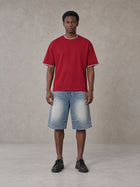 Model wearing SM Sunwash T-shirt in Deep Carmine, front view.