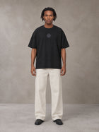 Model wearing SM Still Life NO.01 T-shirt in Midnight Black, front view.