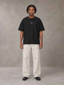 Model wearing SM Still Life NO.01 T-shirt in Midnight Black, front view.