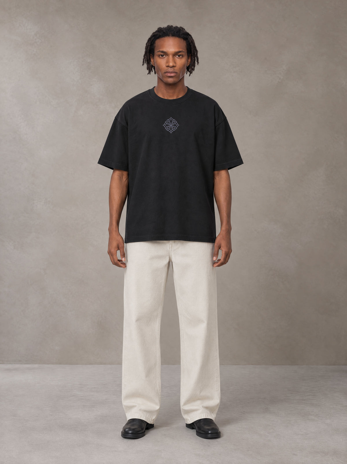 Model wearing SM Still Life NO.01 T-shirt in Midnight Black, front view.