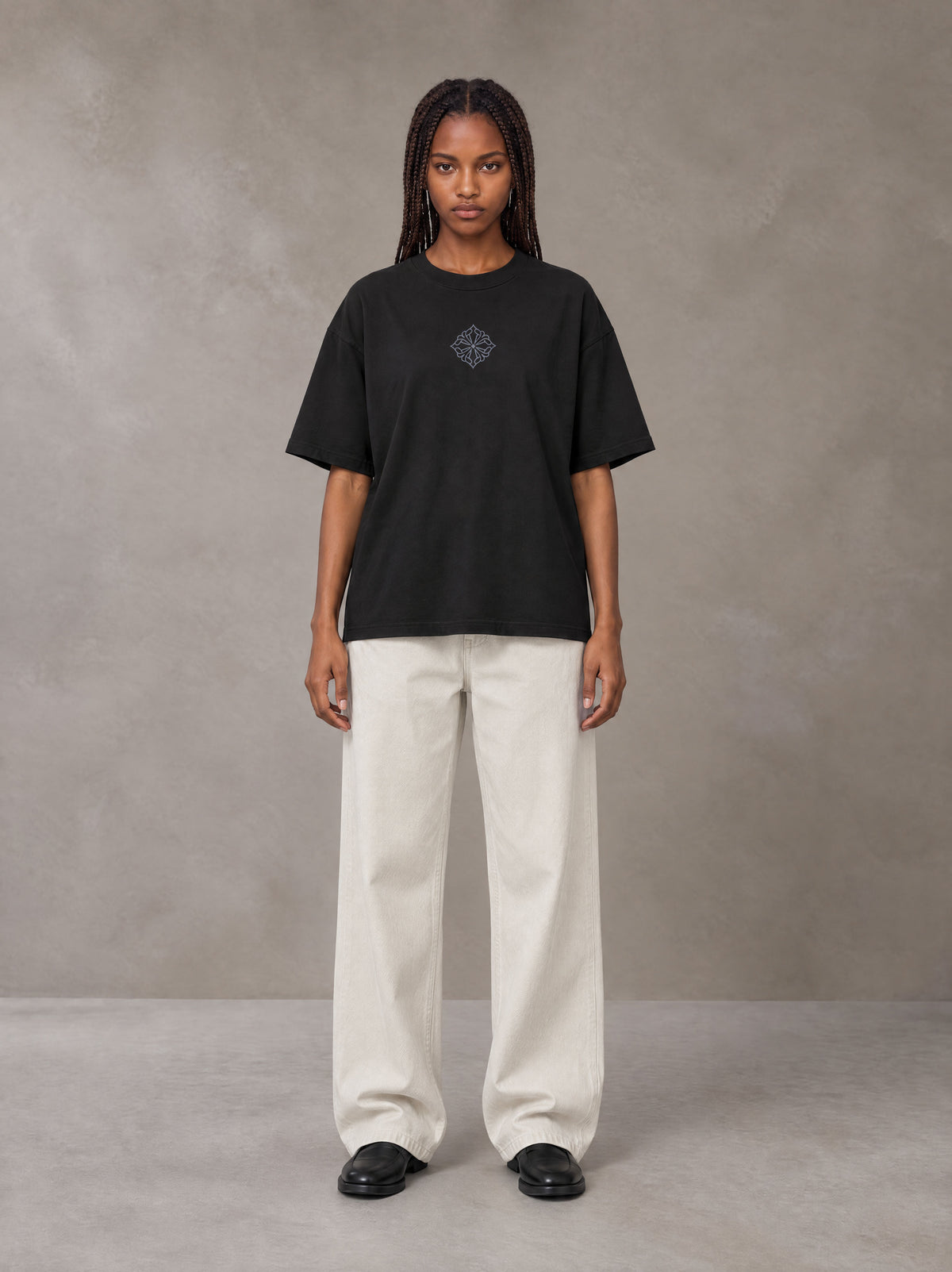 Model wearing SM Still Life NO.01 T-shirt in Midnight Black, front view.