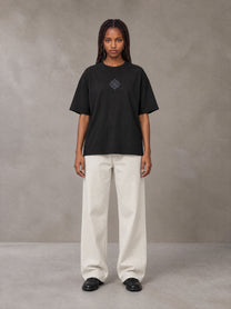 Model wearing SM Still Life NO.01 T-shirt in Midnight Black, front view.
