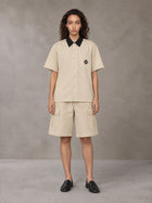 Model wearing SM Eternal Fleur Shirt in Pavlova with SM Eternal Fleur Utility Shorts in Pavlova, front view.