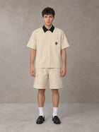 Model wearing SM Eternal Fleur Shirt in Pavlova with SM Eternal Fleur Utility Shorts in Pavlova, front view.