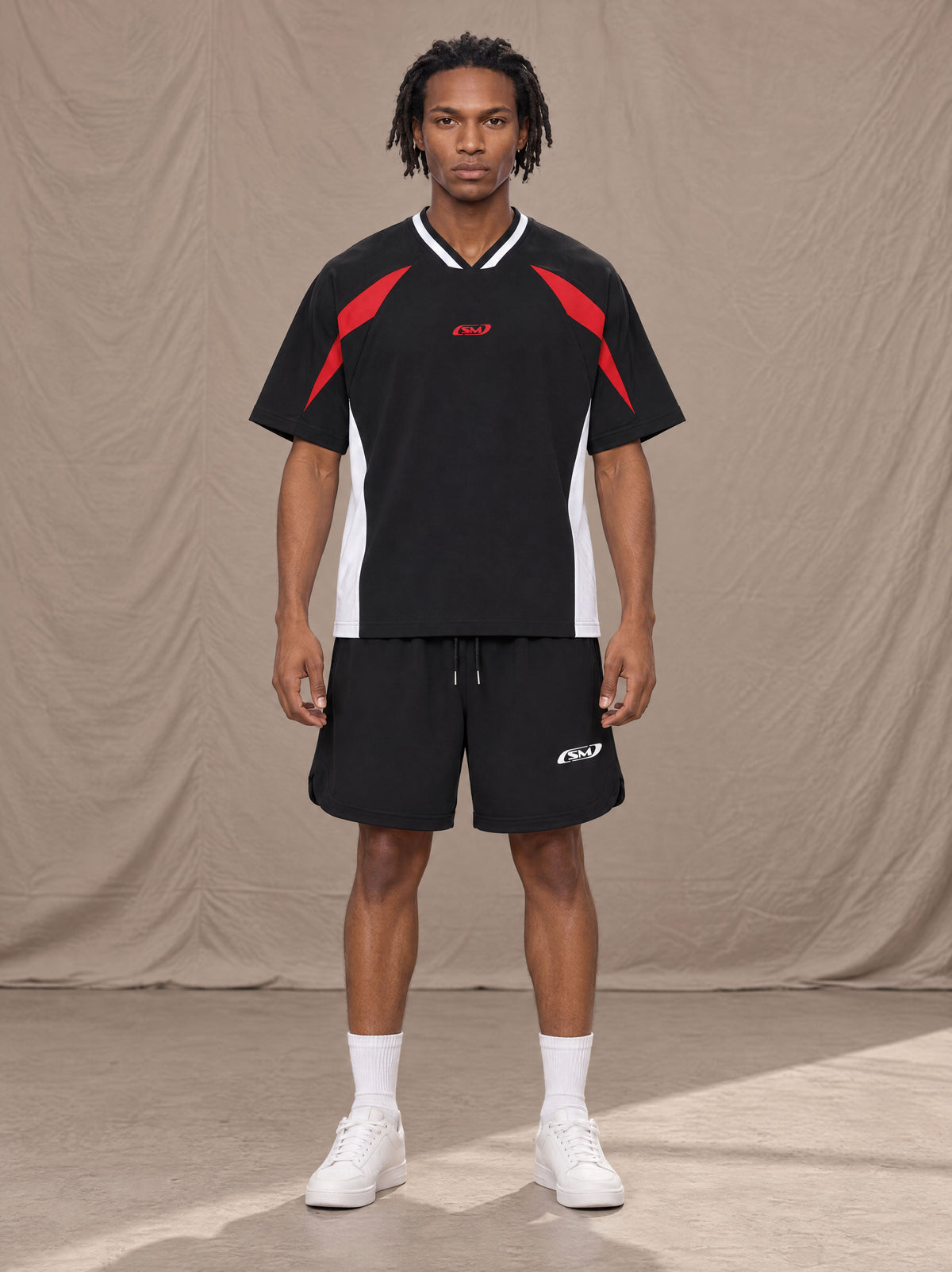 Model wearing SM Motion Vector Jersey in Midnight Black, front view.