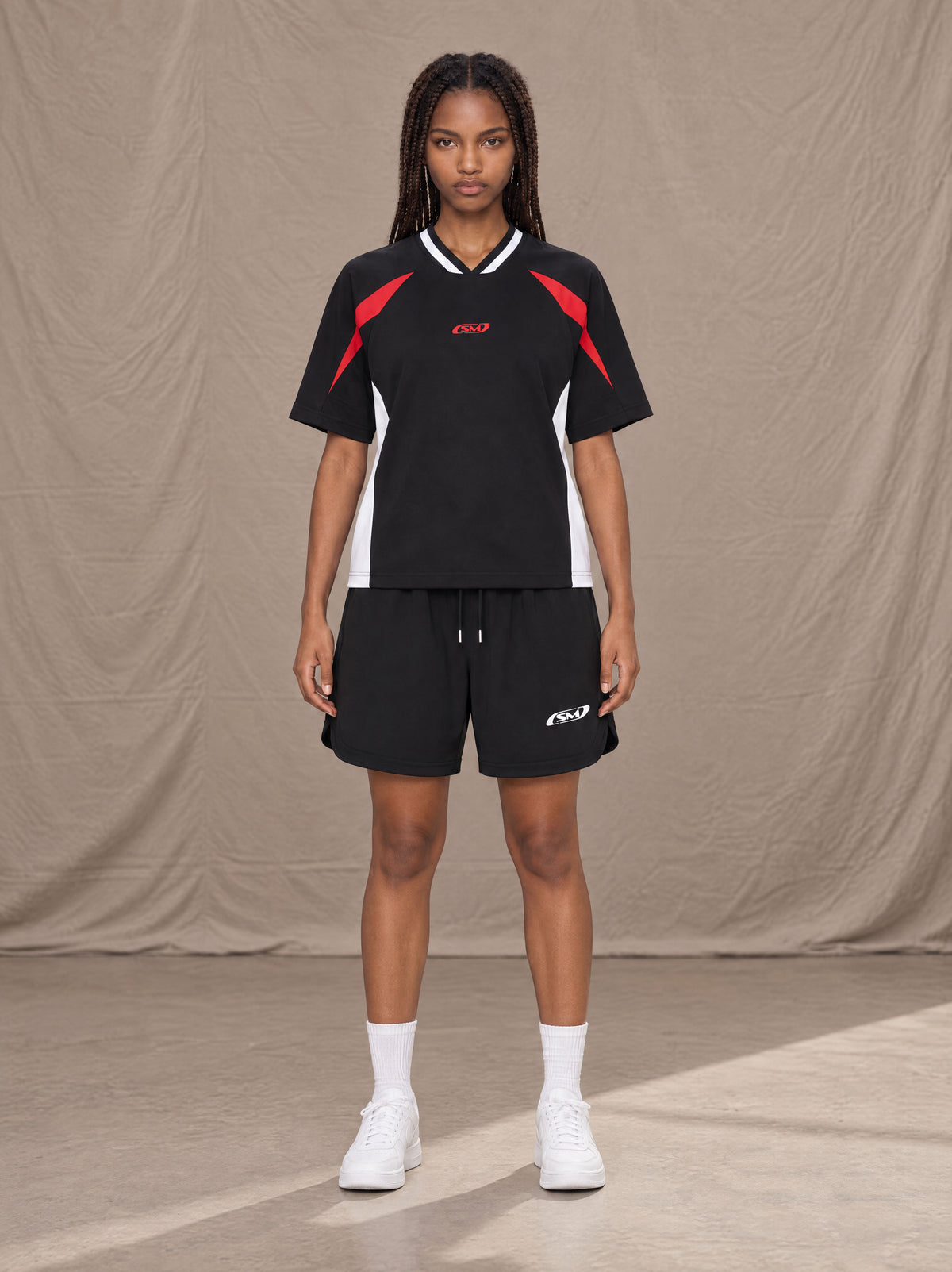 Model wearing SM Motion Vector Jersey in Midnight Black, front view.
