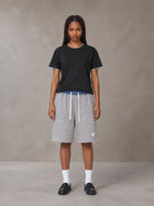 Model wearing SM Plaid Shorts in Floral Grey, front view.