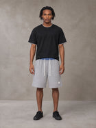 Model wearing SM Plaid Shorts in Floral Grey, front view.