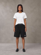 Model wearing SM Plaid Shorts in Midnight Black, front view.