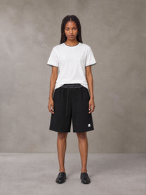 Model wearing SM Plaid Shorts in Midnight Black, front view.