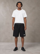 Model wearing SM Plaid Shorts in Midnight Black, front view.