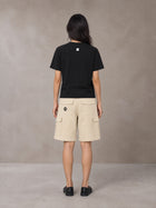 Model wearing SM Sig. Henley T-shirt in Midnight Black, rear view.