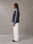 Model wearing SM Royal Emblem Panel Sweatshirt in Chambray, side view.