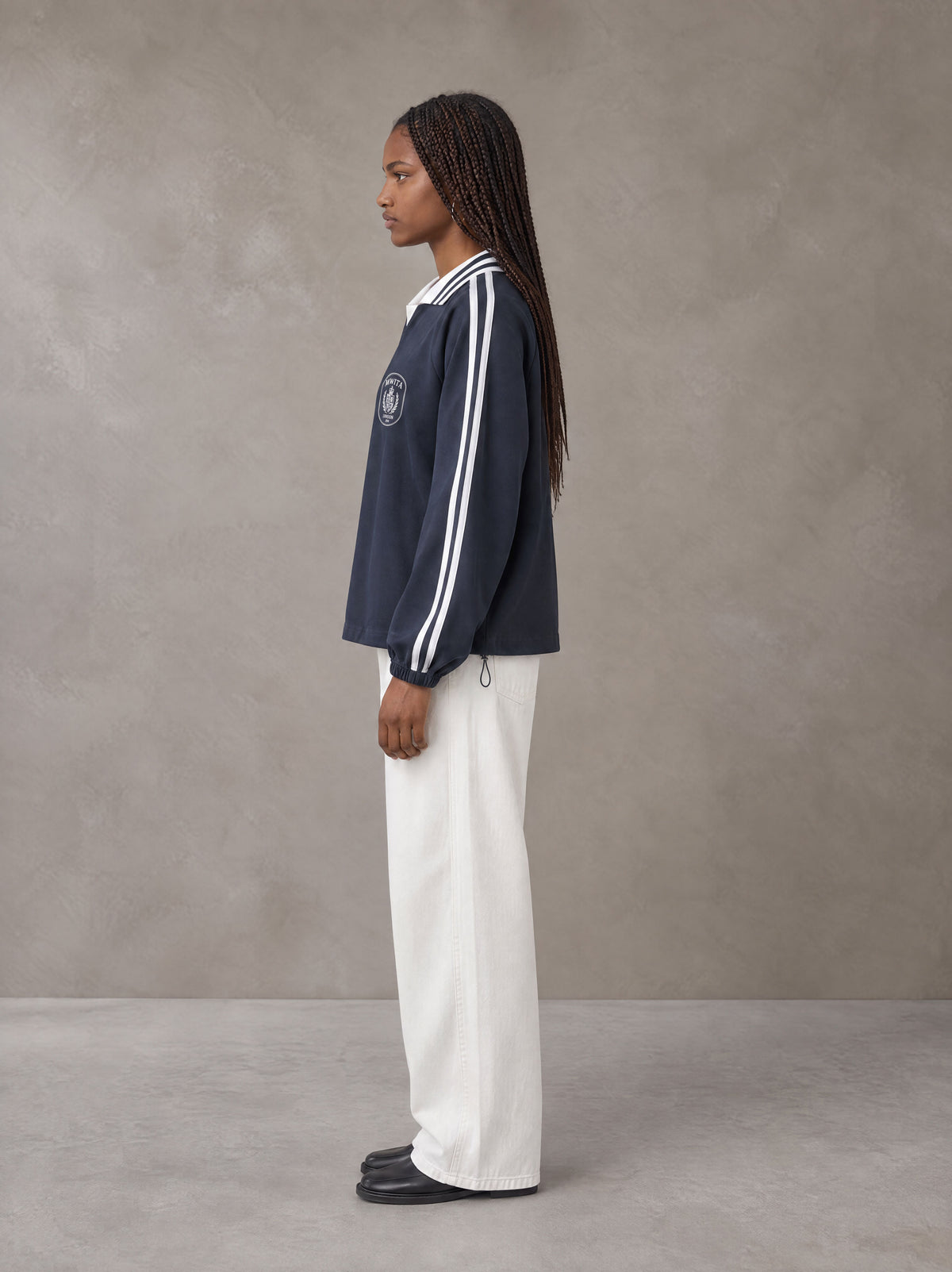 Model wearing SM Royal Emblem Panel Sweatshirt in Chambray, side view.
