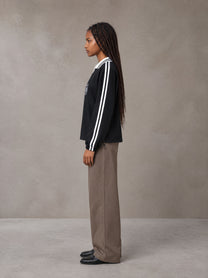 Model wearing SM Royal Emblem Panel Sweatshirt in Midnight Black, side view.