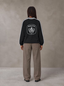 Model wearing SM Royal Emblem Panel Sweatshirt in Midnight Black, rear view.