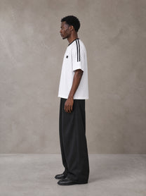 Model wearing SM Sig. Striped T-shirt in Lucent White, side view.