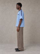 Model wearing SM Sig. Striped T-shirt in Blair Blue, side view.
