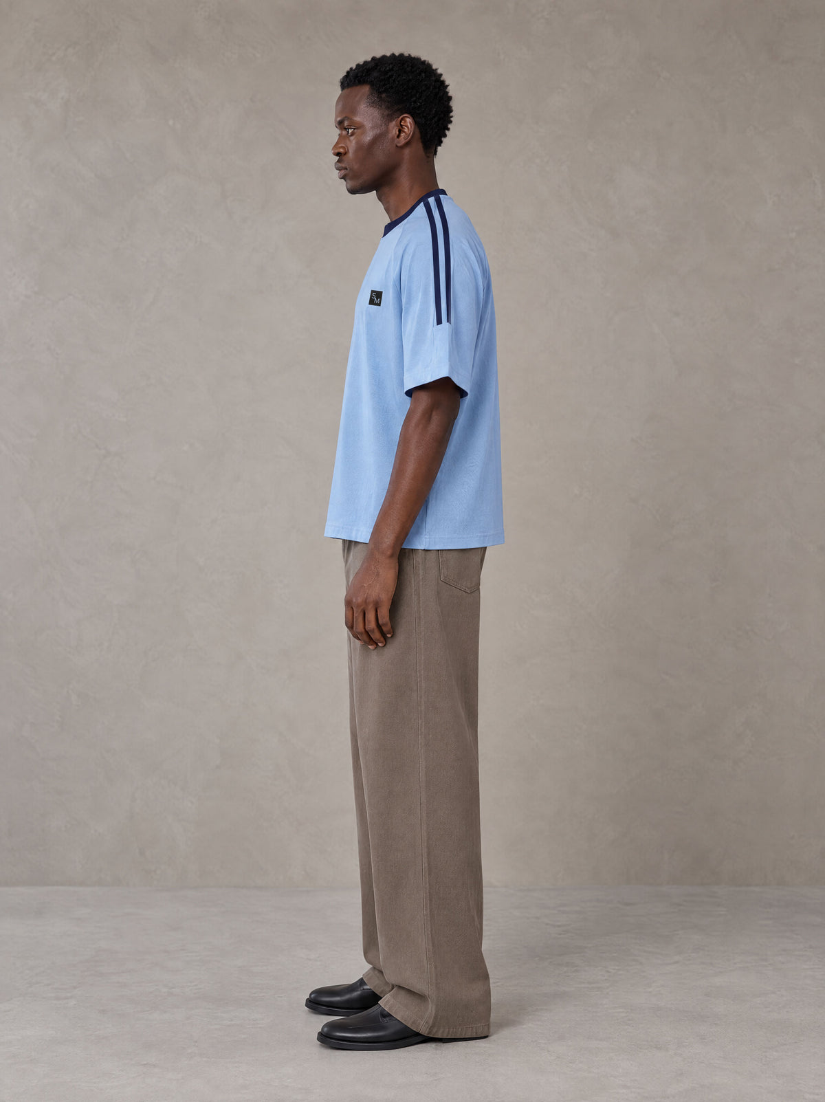 Model wearing SM Sig. Striped T-shirt in Blair Blue, side view.