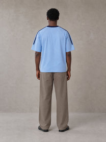 Model wearing SM Sig. Striped T-shirt in Blair Blue, rear view.