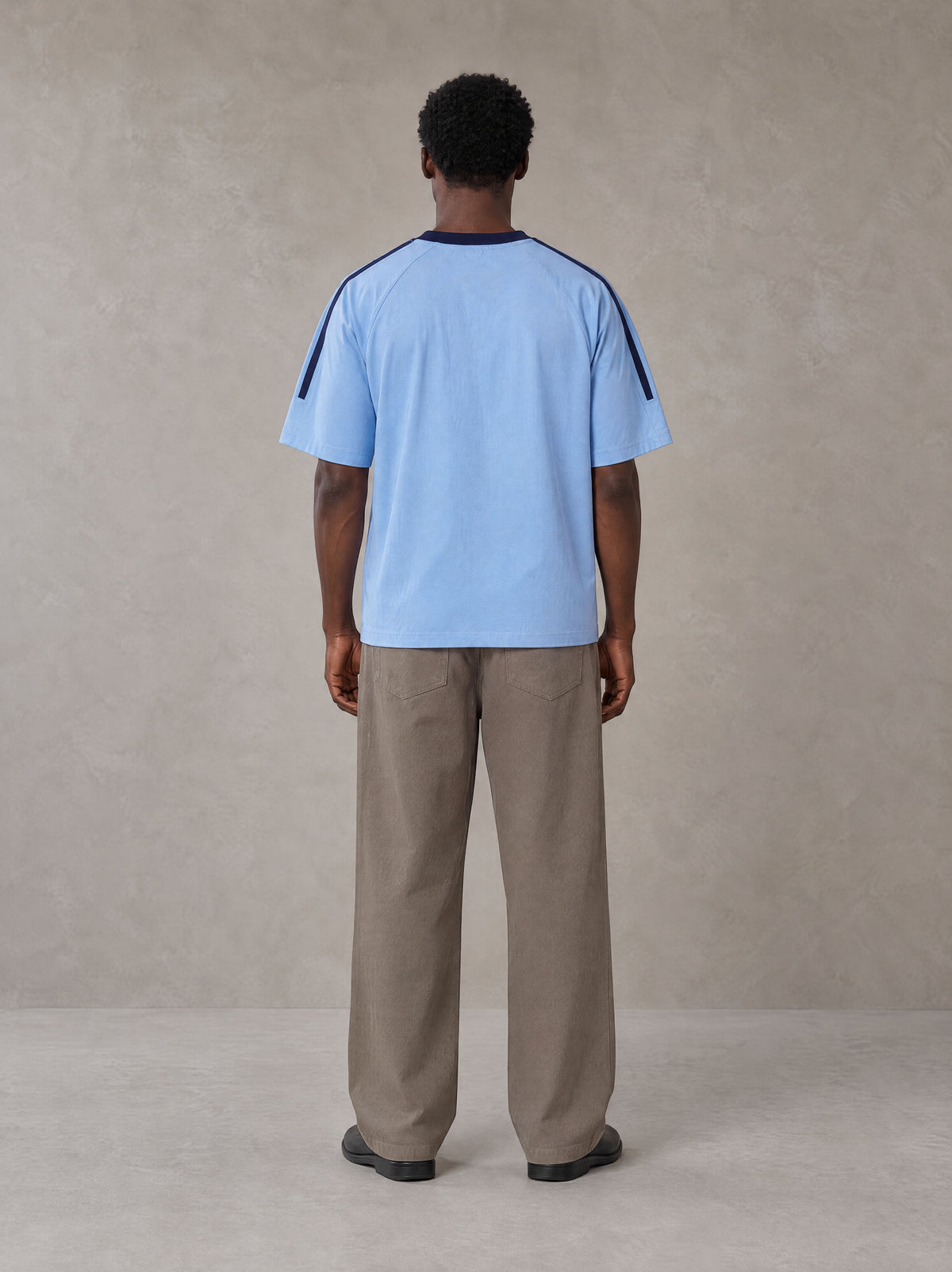 Model wearing SM Sig. Striped T-shirt in Blair Blue, rear view.