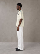 Model wearing SM Sig. Striped T-shirt in Natural Flax, side view.