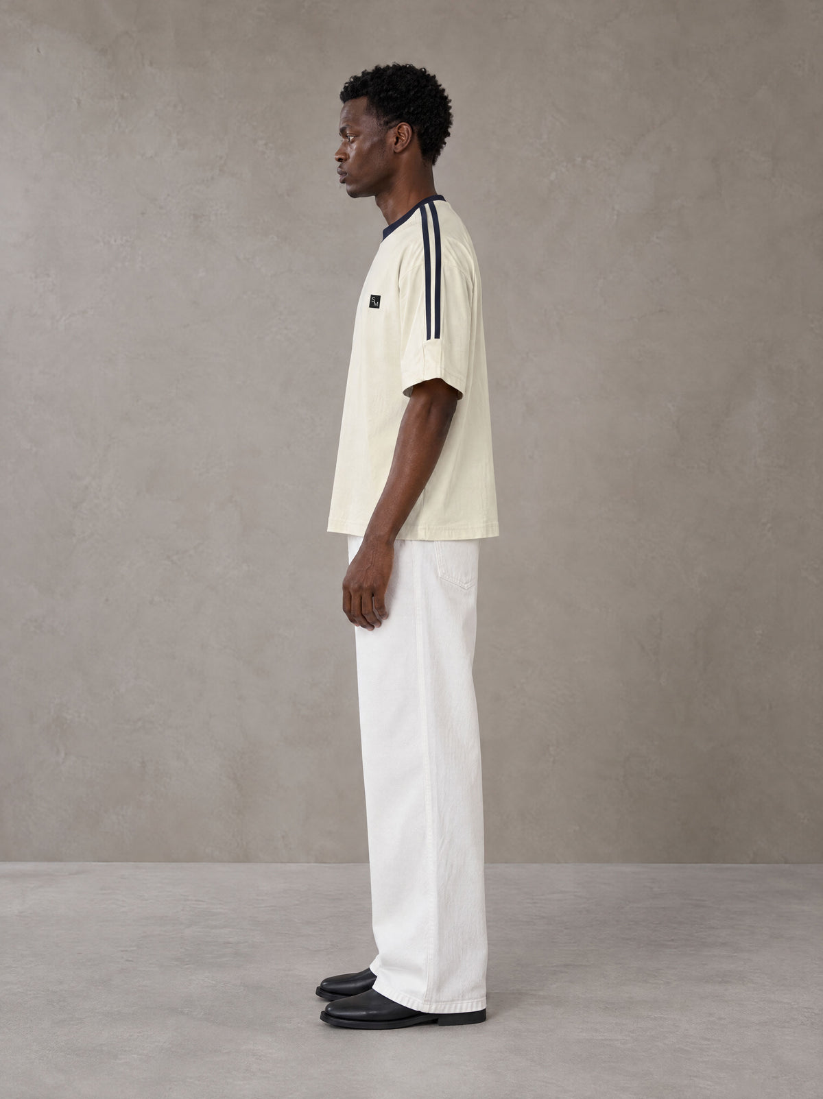 Model wearing SM Sig. Striped T-shirt in Natural Flax, side view.