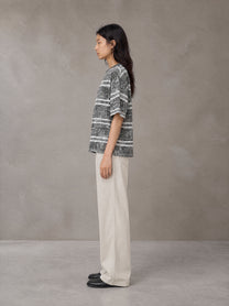 Model wearing SM Sig. Snow Washed Striped T-shirt in Pure Grey, side view.