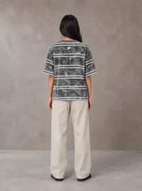 Model wearing SM Sig. Snow Washed Striped T-shirt in Pure Grey, rear view.