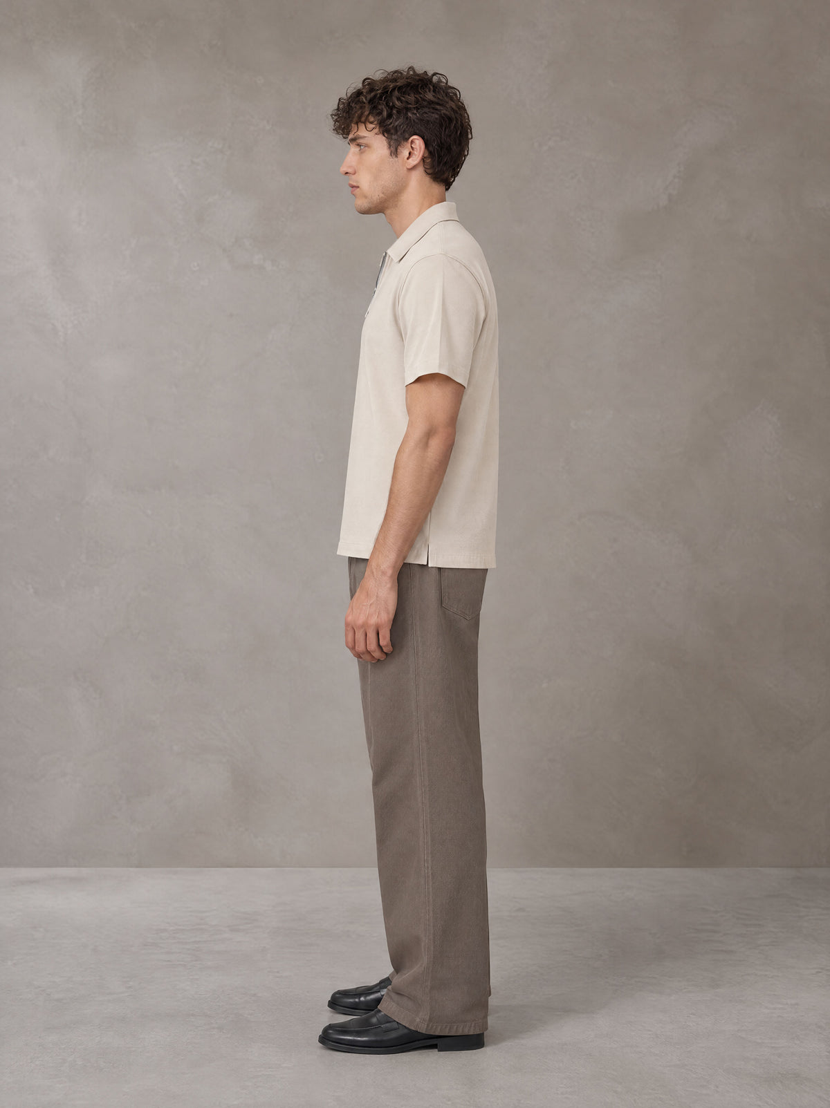 Model wearing SM Sig. Half-Zip Polo Shirt in Oatmeal Cookie, side view.