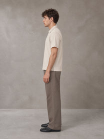 Model wearing SM Sig. Half-Zip Polo Shirt in Oatmeal Cookie, side view.
