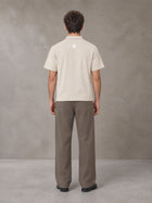 Model wearing SM Sig. Half-Zip Polo Shirt in Oatmeal Cookie, rear view.