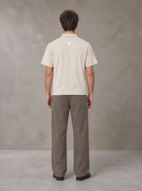 Model wearing SM Sig. Half-Zip Polo Shirt in Oatmeal Cookie, rear view.